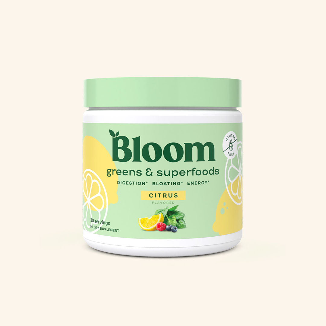 A container of Bloom greens & superfoods powder in Citrus flavor, labeled as supporting digestion, bloating, and energy. 30 servings.