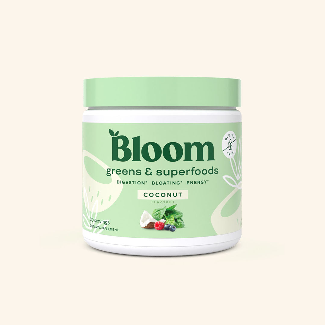 A container of Bloom greens & superfoods powder in Coconut flavor, labeled as supporting digestion, bloating, and energy. 30 scoop servings.