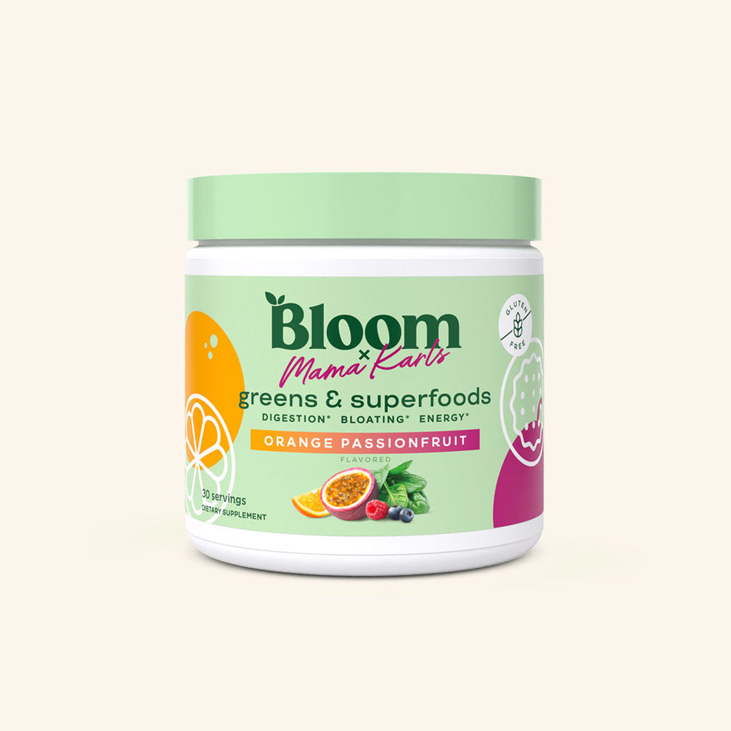 A container of Bloom greens & superfoods powder in Orange Passionfruit flavor in collaboration with Mama Karls, labeled as supporting digestion, bloating, and energy. 30 servings.