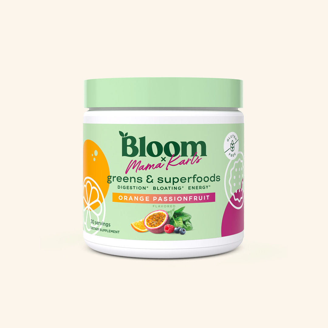 A container of Bloom greens & superfoods powder in Orange Passionfruit flavor in collaboration with Mama Karls, labeled as supporting digestion, bloating, and energy. 30 servings.