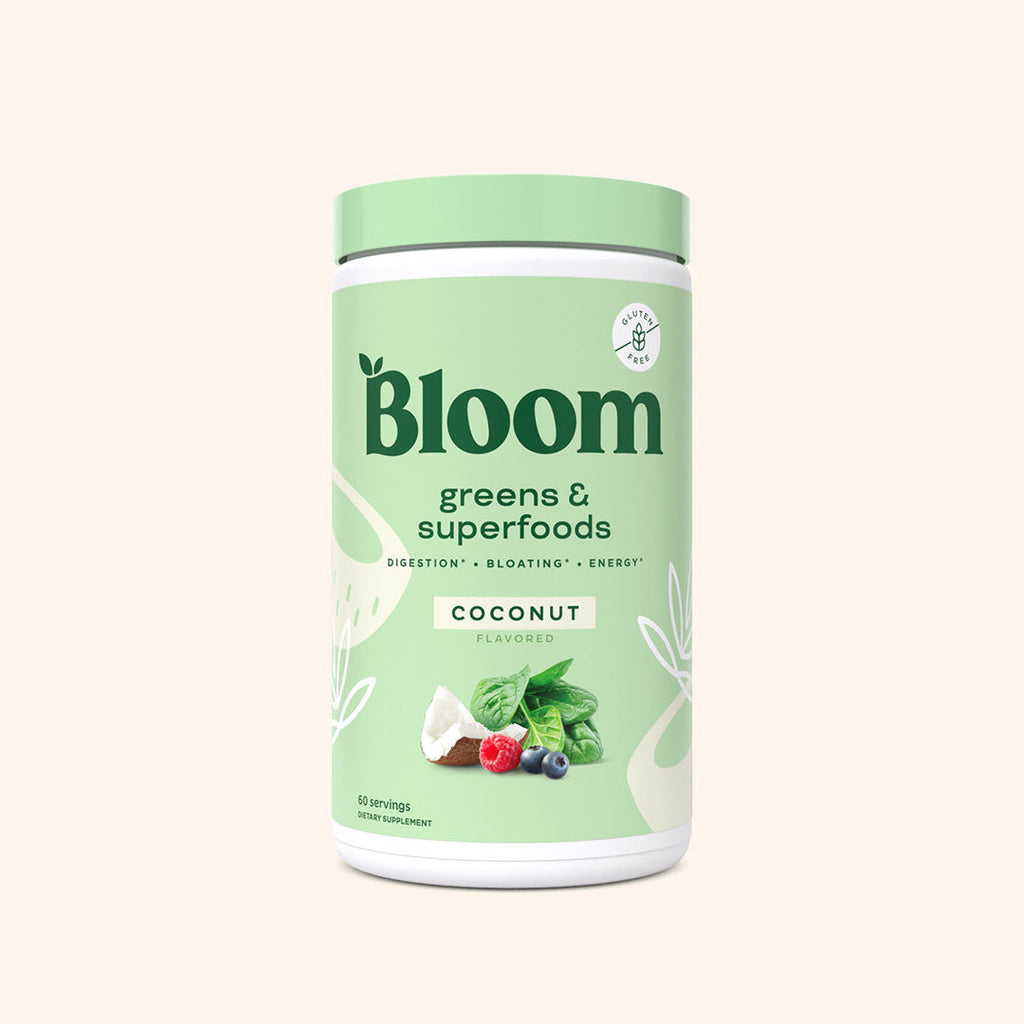 A container of Bloom greens & superfoods powder in Coconut flavor, labeled as supporting digestion, bloating, and energy. 60 scoop servings.